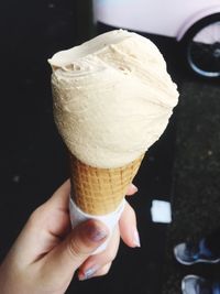 Cropped hand of woman holding ice cream cone