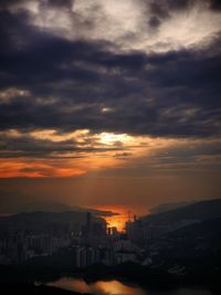 High angle view of buildings against dramatic sky during sunset