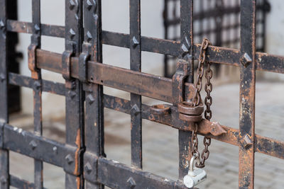 Close-up of padlock on metal fence