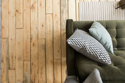 Low section of woman sitting on hardwood floor