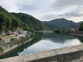 Scenic view of lake by mountains against sky