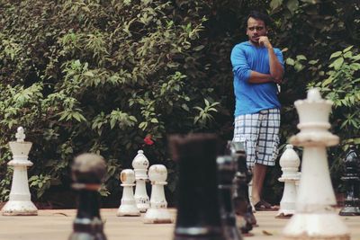 Young man contemplating on chess board