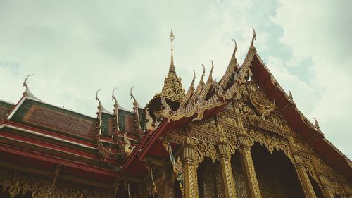 Low angle view of temple against cloudy sky