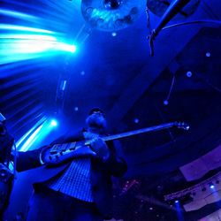 Low angle view of illuminated lighting equipment at night