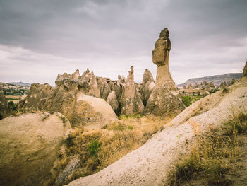 Rock formations on landscape against sky