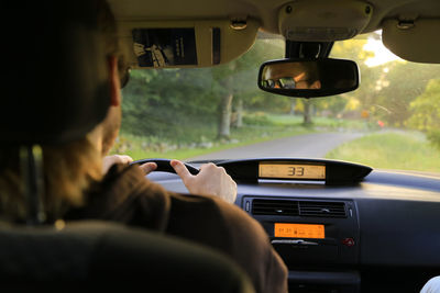 Rear view of person driving car