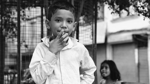 Portrait of boy holding outdoors