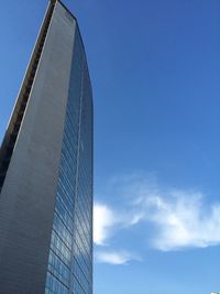 Low angle view of modern building against blue sky