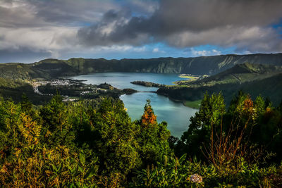 Scenic view of lake and mountains against sky