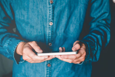 Midsection of woman using mobile phone