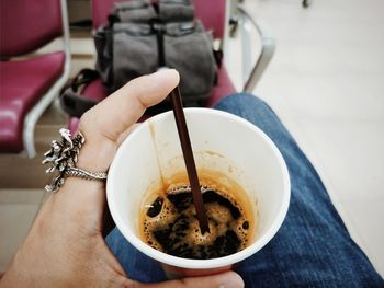 Midsection of person holding coffee cup