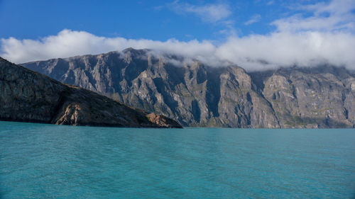 Scenic view of sea and mountains against sky