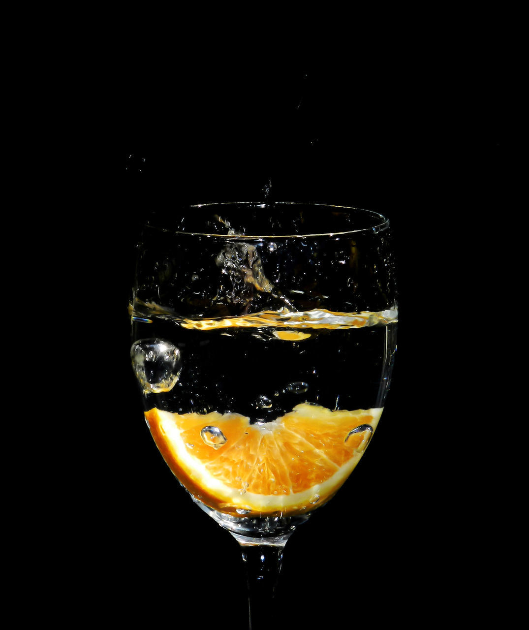 CLOSE-UP OF GLASS AGAINST BLACK BACKGROUND