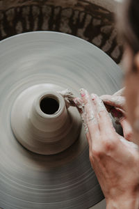 Midsection of woman at pottery workshop