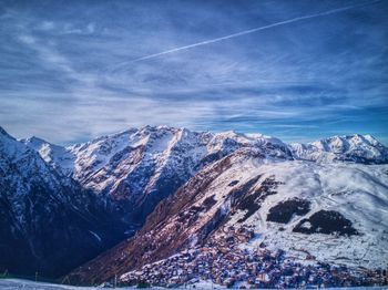 Scenic view of snowcapped mountains against sky