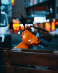 Close-up of illuminated orange car on street