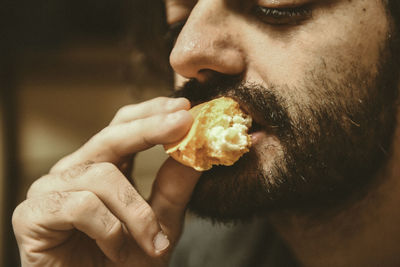 Close-up of man eating cake