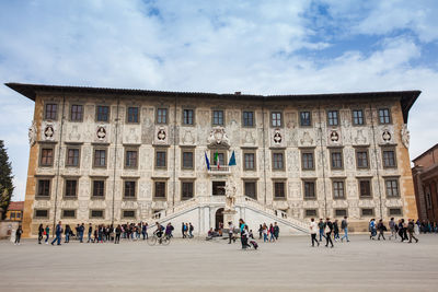 Tourists and locals at the palazzo della carovana built in 1564 located at knights square in pisa