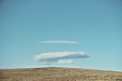 Scenic view of desert against blue sky