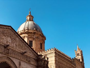 Low angle view of historical building against clear blue sky