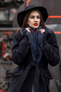 Portrait of woman wearing hat standing outdoors