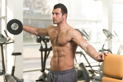 Muscular man exercising in gym