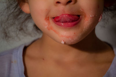 Close-up of girl sticking out tongue