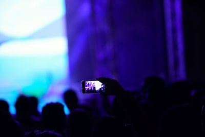 People photographing at music concert