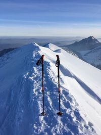 People skiing on snowcapped mountain against sky