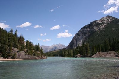 Scenic view of sea and mountains against sky