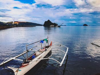 Boats moored on sea against sky