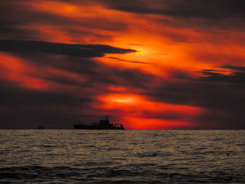 Scenic view of sea against orange sky