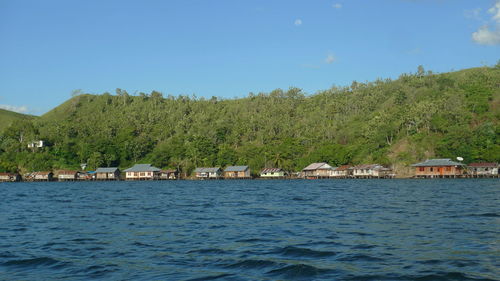 Scenic view of sea and buildings against sky