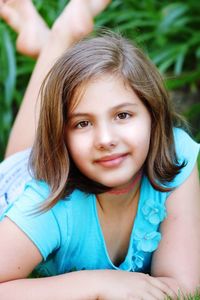 Portrait of girl lying outdoors