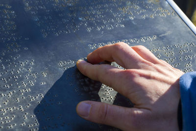 Braille text and hand, blind people book, white and reading with hand