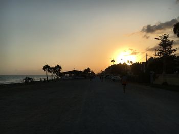 Silhouette of people walking on beach