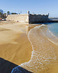 Scenic view of beach against clear sky