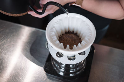 Close-up of hand holding coffee cup