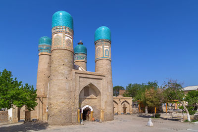 Low angle view of historic building against clear blue sky