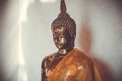 Statue of buddha against building