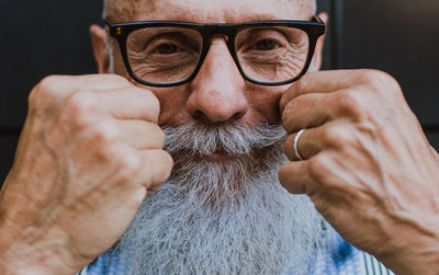 Close-up of senior hipster with white beard and mustache