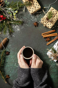 High angle view of hand holding coffee cup