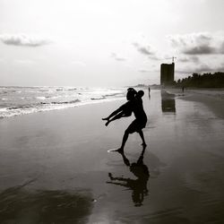 Full length of man on beach against sky