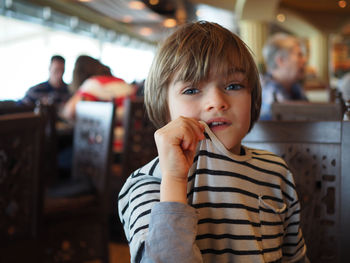 Portrait of boy sitting in restaurant