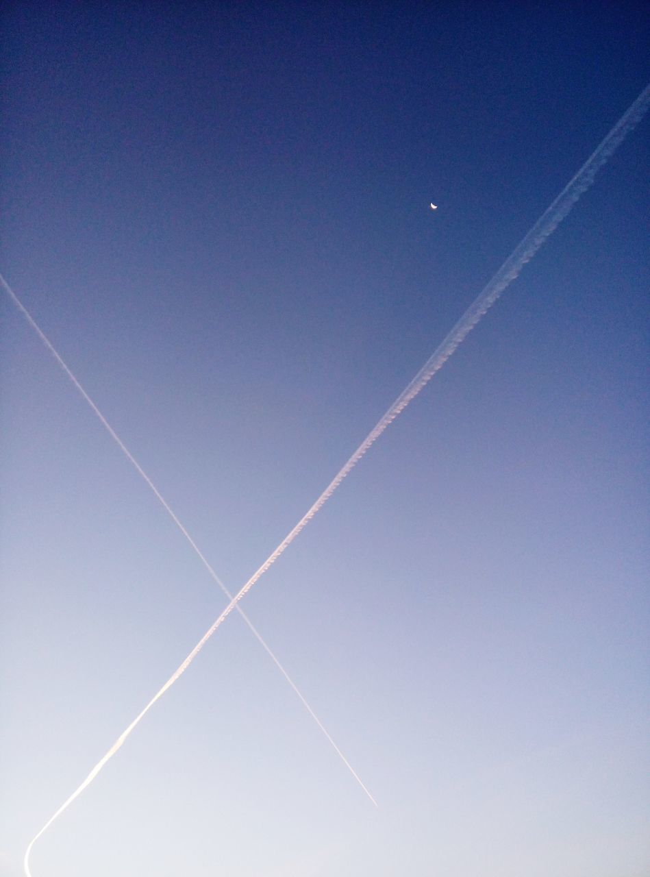 LOW ANGLE VIEW OF VAPOR TRAIL IN BLUE SKY