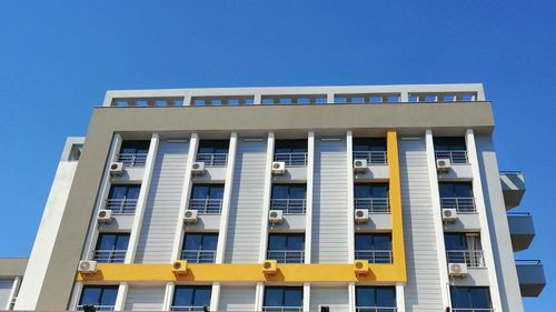 Low angle view of building against clear blue sky