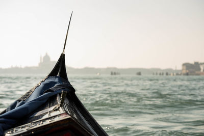 Close-up of sailboat in sea against clear sky