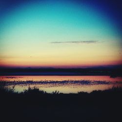 Scenic view of calm lake at sunset