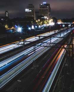 Blurred image of trains moving on tracks at night