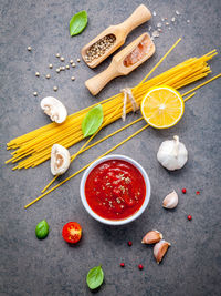 Close-up of uncooked pasta with ingredients on table